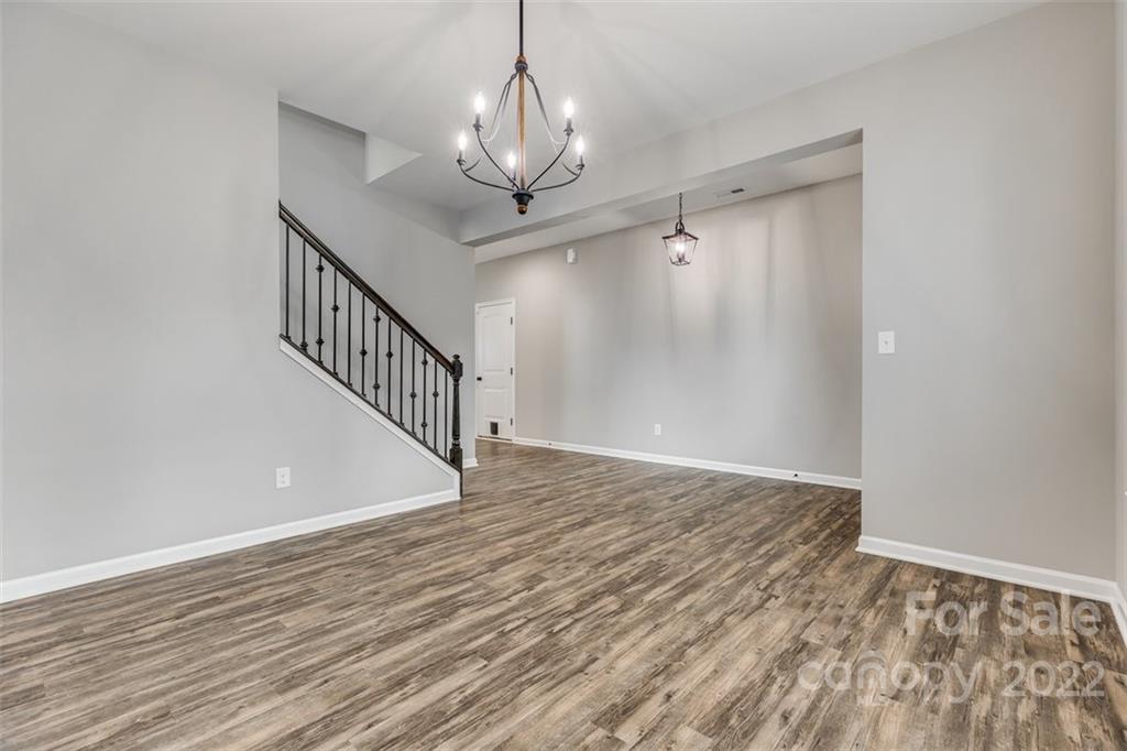 6403 Bluegill Road Charlotte, NC 28216 - Photo 5 of 48 a view of an empty room with wooden floor and a window