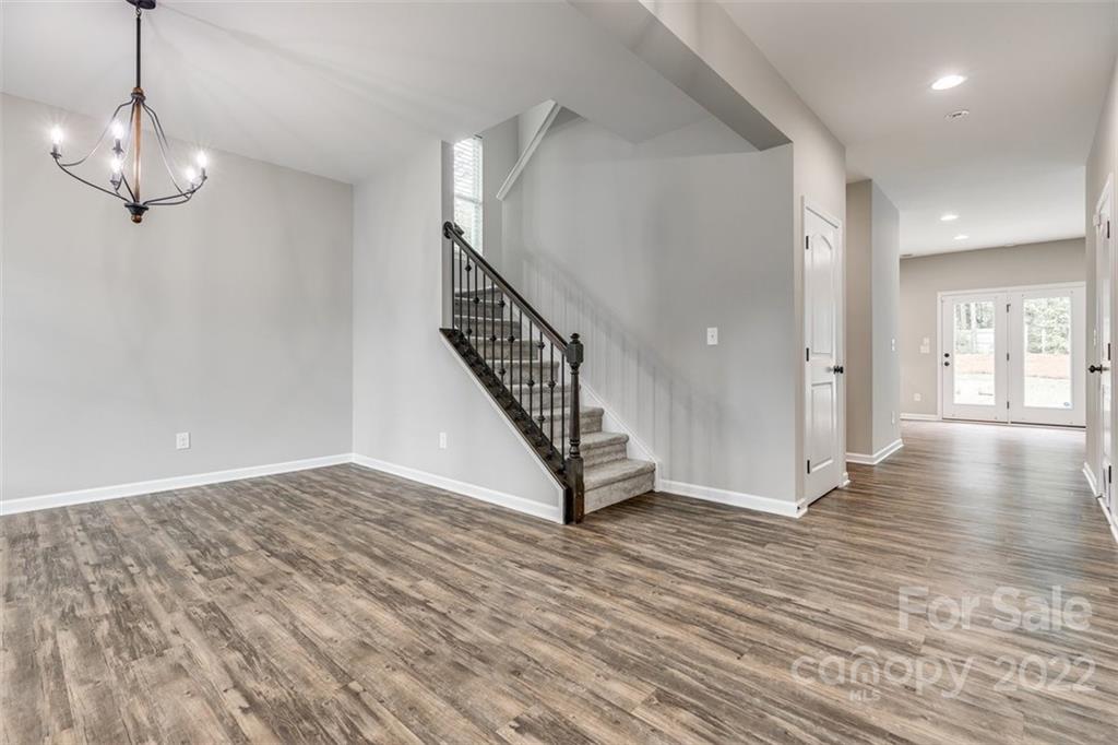 6403 Bluegill Road Charlotte, NC 28216 - Photo 7 of 48 a view of an empty room with wooden floor and staircase