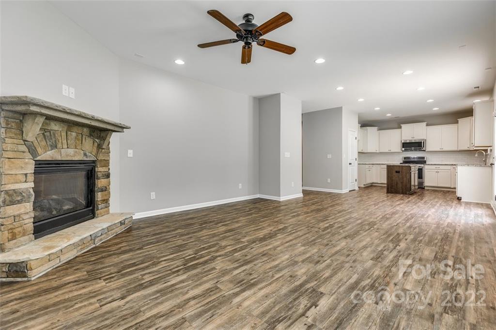 6403 Bluegill Road Charlotte, NC 28216 - Photo 8 of 48 a view of a kitchen with a stove a ceiling fan and kitchen view