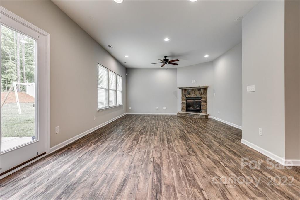 6403 Bluegill Road Charlotte, NC 28216 - Photo 10 of 48 a view of empty room with wooden floor and fan
