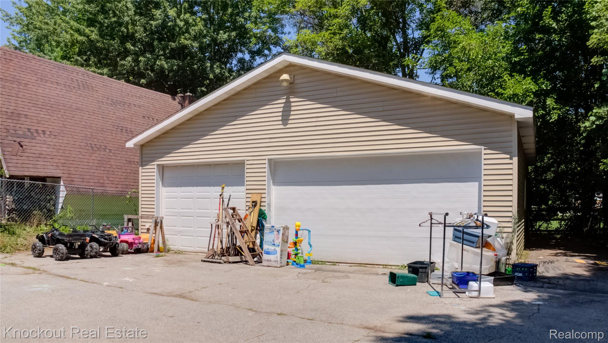 4195 Williamson Road Saginaw, MI 48601 - Photo 50 of 50 Detached two-car garage featuring horizontal vinyl siding, two panel garage doors, and an exterior light fixture