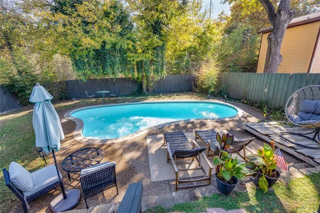 a view of a backyard with sitting area