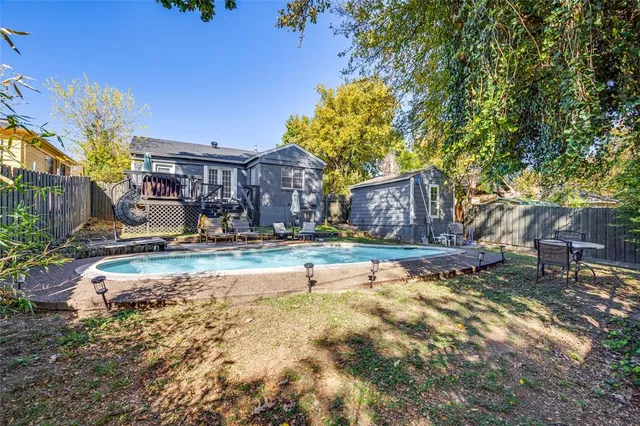 a view of a house with pool and sitting area