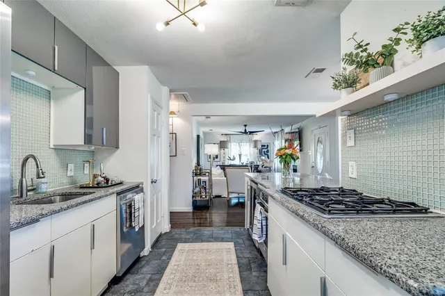 a kitchen with a sink stove and cabinets