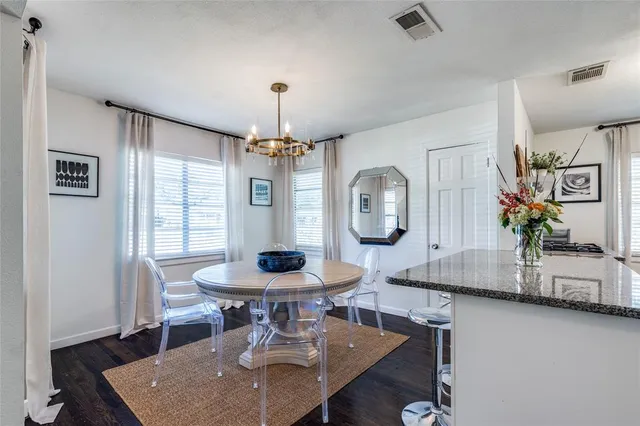 a view of a dining room with furniture and a chandelier