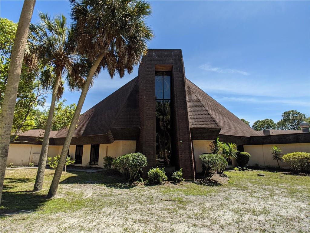 5844 Pine Hill Road Port Richey, FL 34668 - Photo 1 of 1 a view of a house with a yard