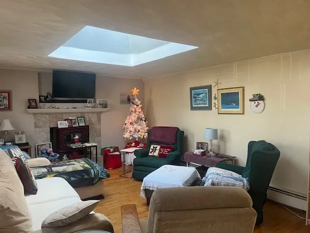 a living room with furniture a flat screen tv and a fireplace