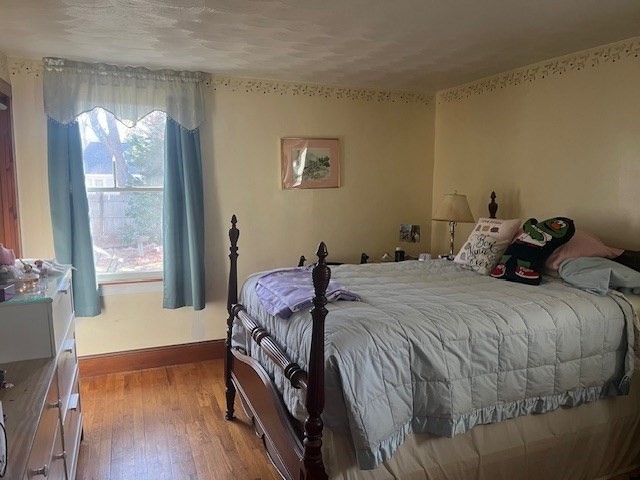 23 Lakewood Road Yarmouth, MA 02664 - Photo 8 of 15 a bedroom with a bed and wooden floor