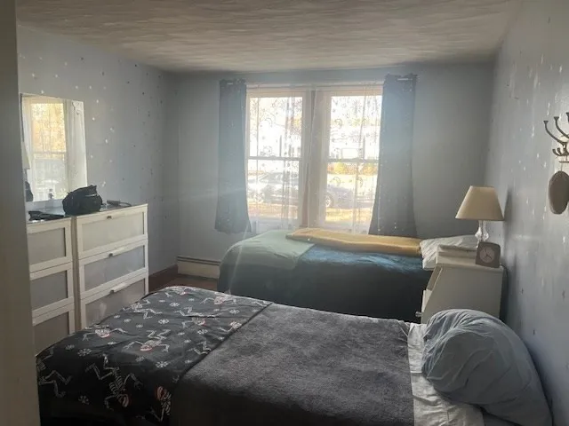 a bedroom with a bed and window