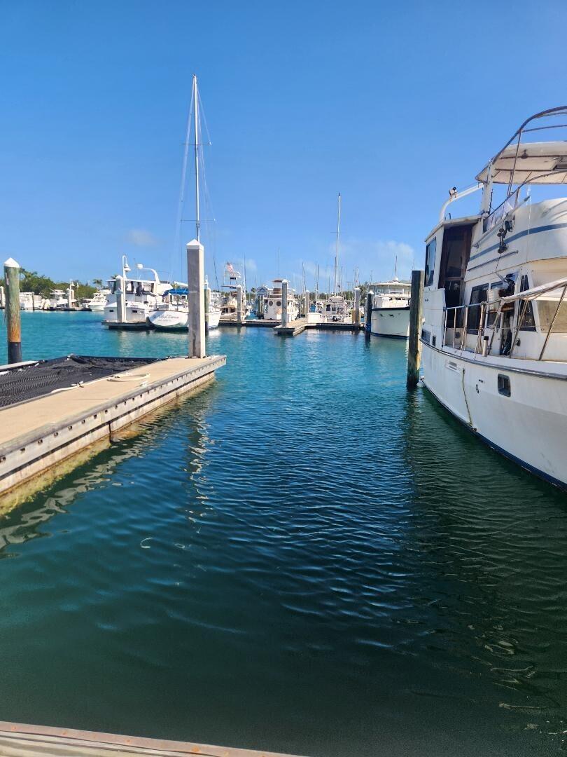 5555 College Road, Unit CONCH 8 Key West, FL 33040 - Photo 2 of 22 a view of a lake with lawn chairs