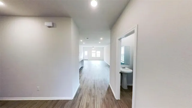 a view of gallery with wooden floor