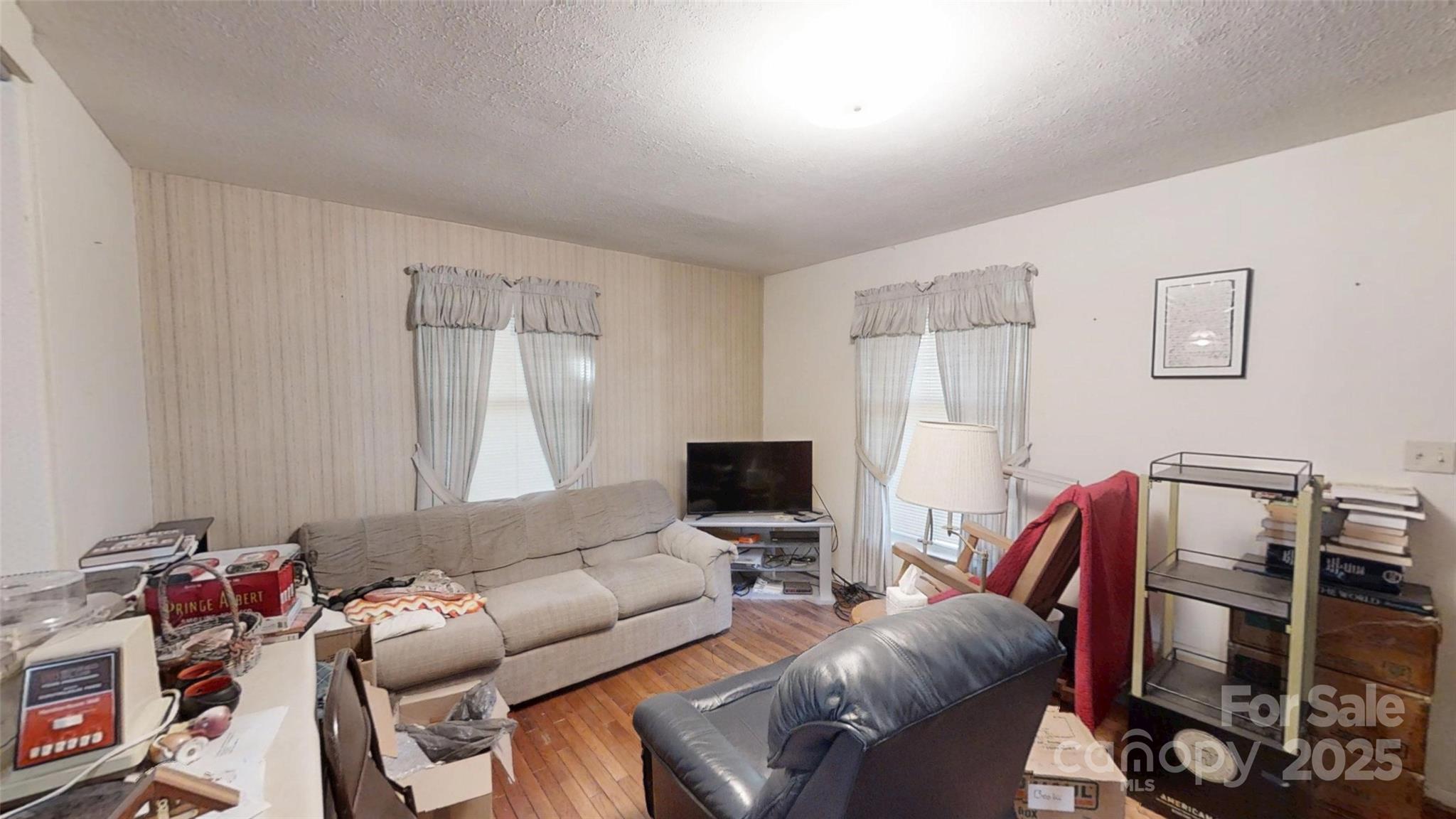 111 Cisco Road Asheville, NC 28805 - Photo 3 of 30 a living room with furniture a flat screen tv and a window
