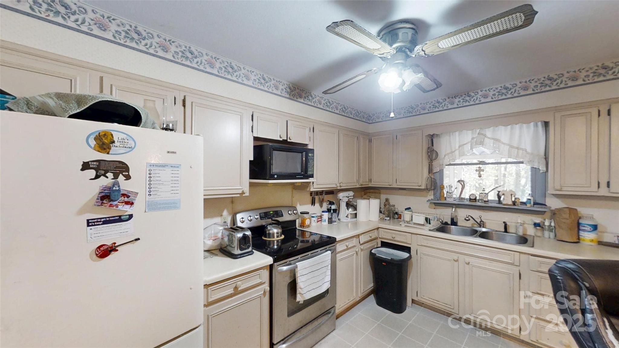111 Cisco Road Asheville, NC 28805 - Photo 6 of 30 a kitchen with a refrigerator a stove a microwave and cabinets