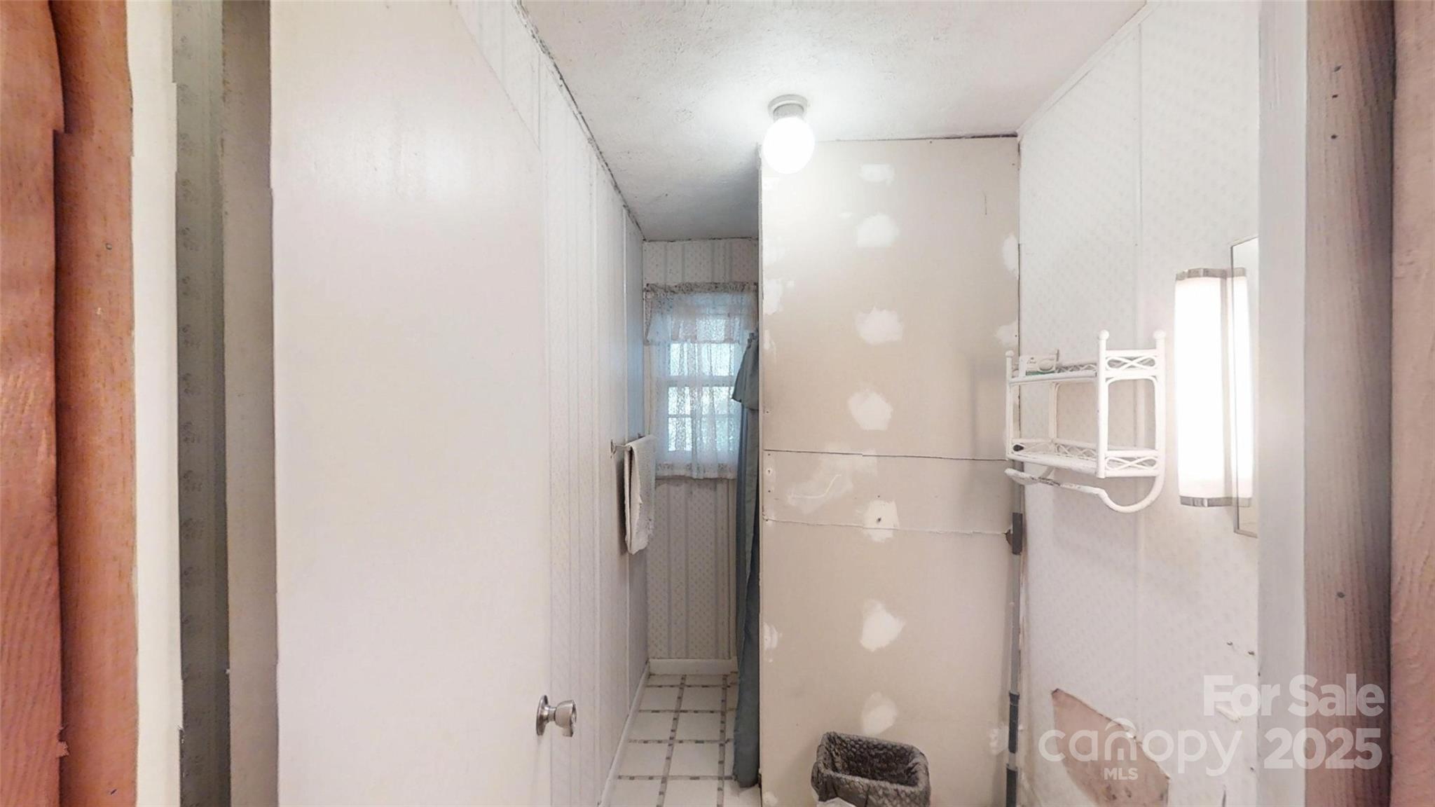 111 Cisco Road Asheville, NC 28805 - Photo 10 of 30 a bathroom with a glass shower door