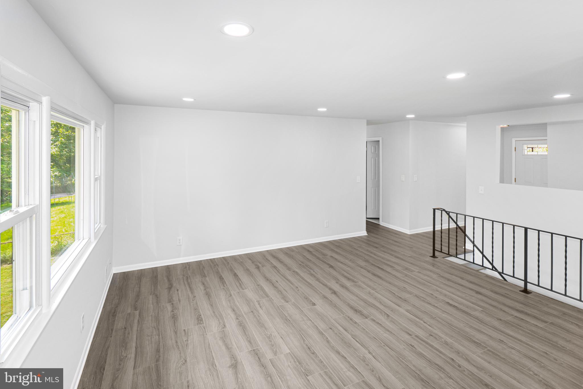 3311 Michele Lane Mitchellville, MD 20721 - Photo 11 of 44 an empty room with wooden floor and windows