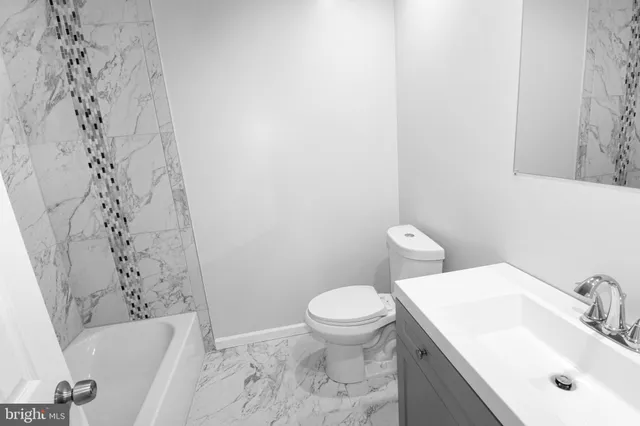 a bathroom with a sink toilet and bathtub