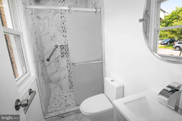 a white toilet sitting next to a shower curtain