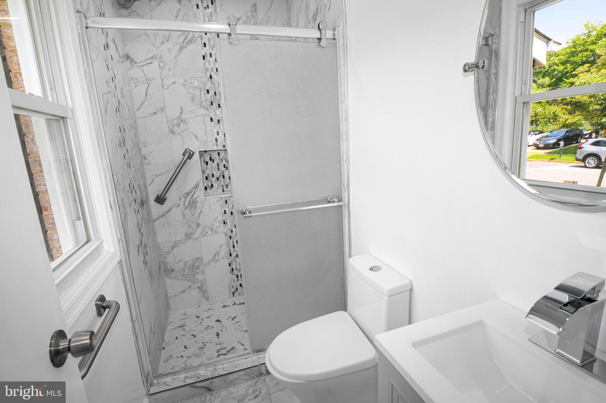 3311 Michele Lane Mitchellville, MD 20721 - Photo 17 of 44 a white toilet sitting next to a shower curtain