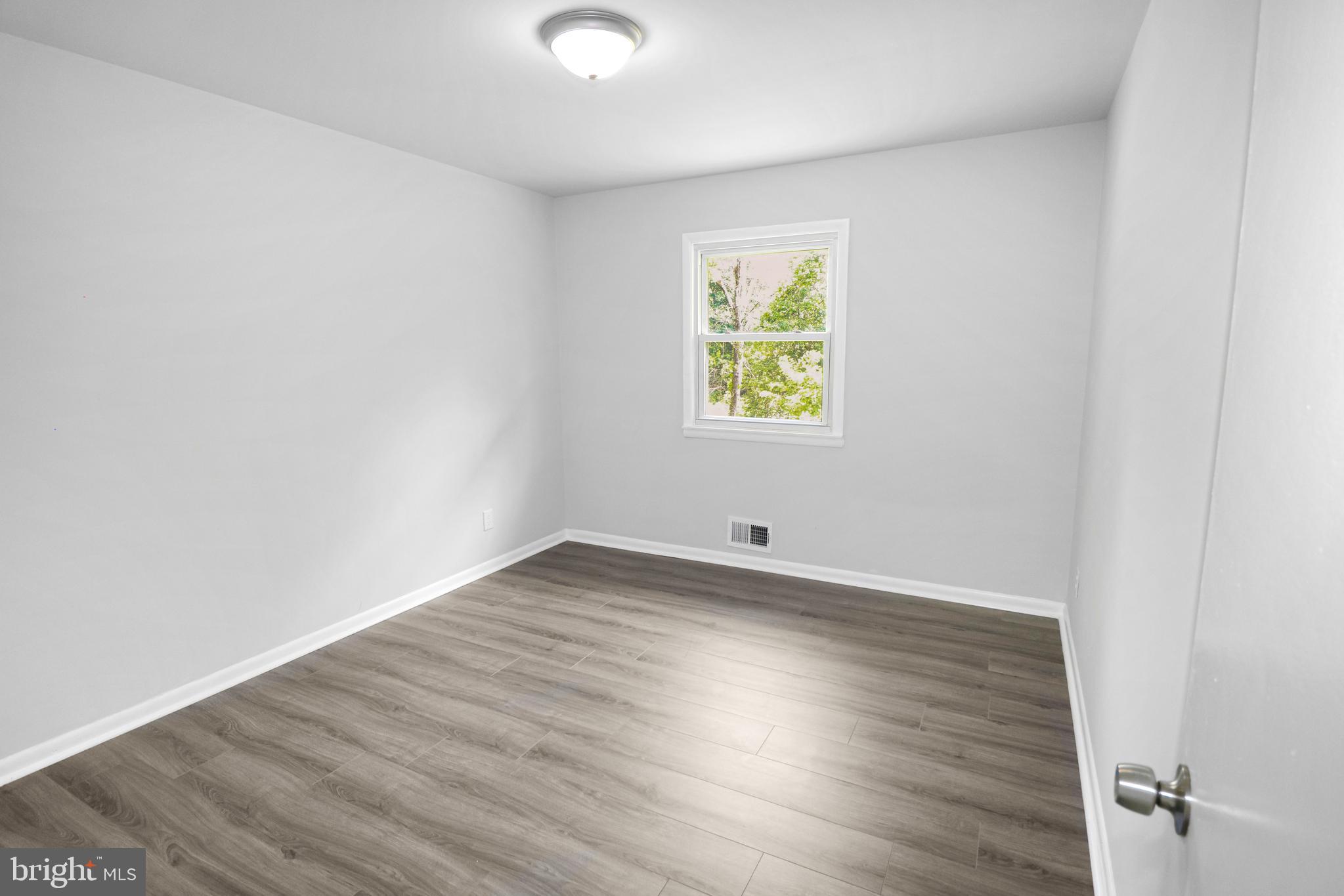 3311 Michele Lane Mitchellville, MD 20721 - Photo 20 of 44 an empty room with wooden floor and a window
