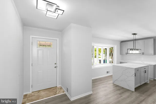 a view of a kitchen with wooden floor and windows