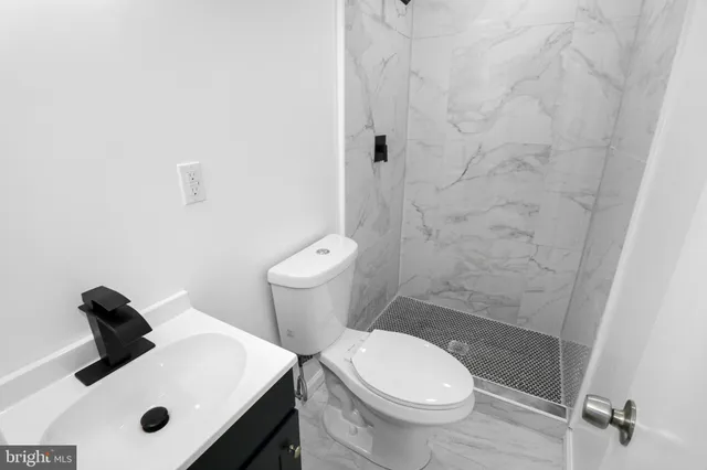 a white toilet sitting next to a bathroom sink