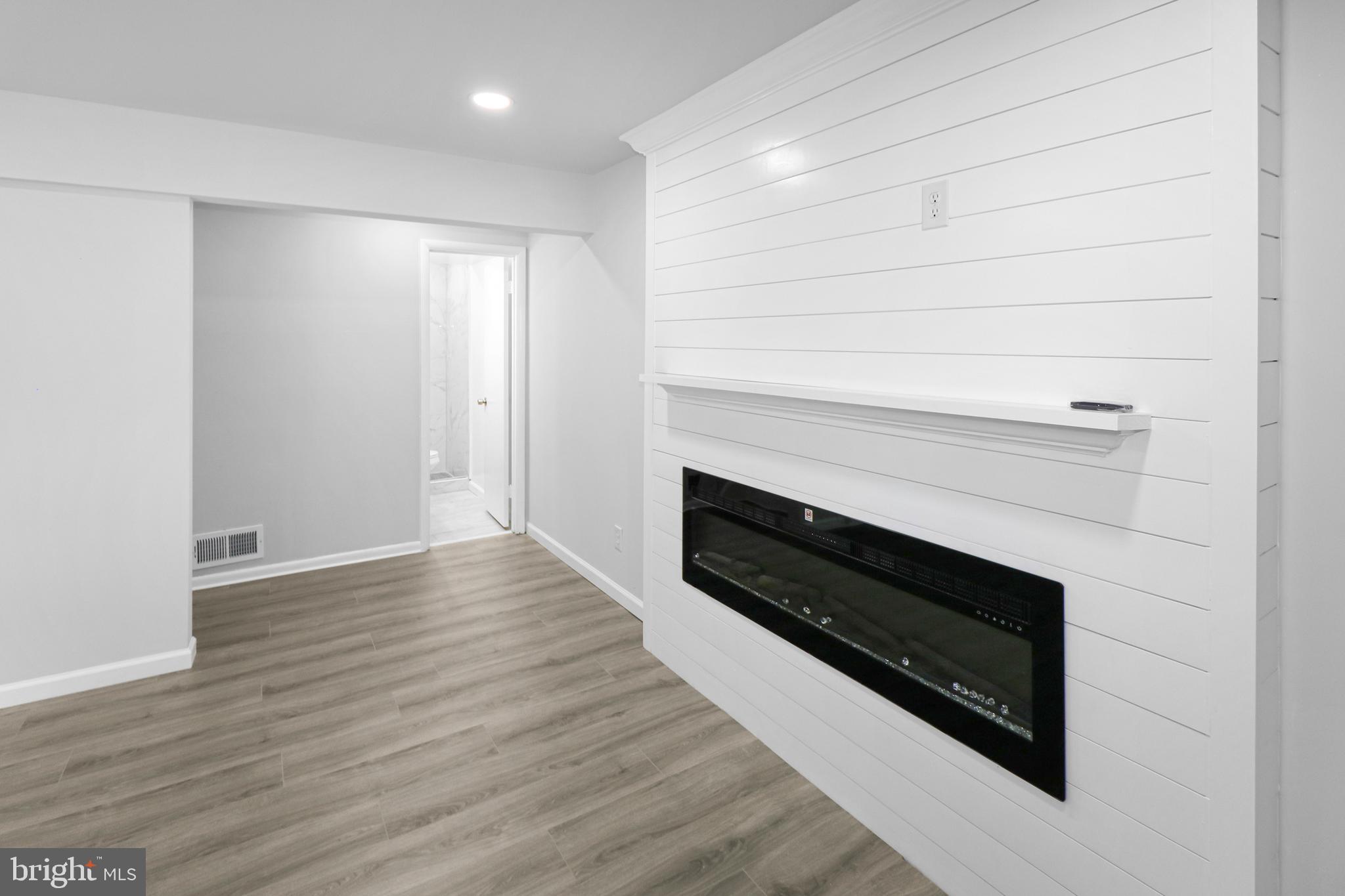 3311 Michele Lane Mitchellville, MD 20721 - Photo 27 of 44 a view of wooden floor and a fireplace in a room