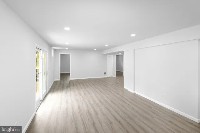 a view of a room with wooden floor and window