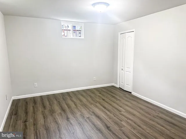an empty room with wooden floor