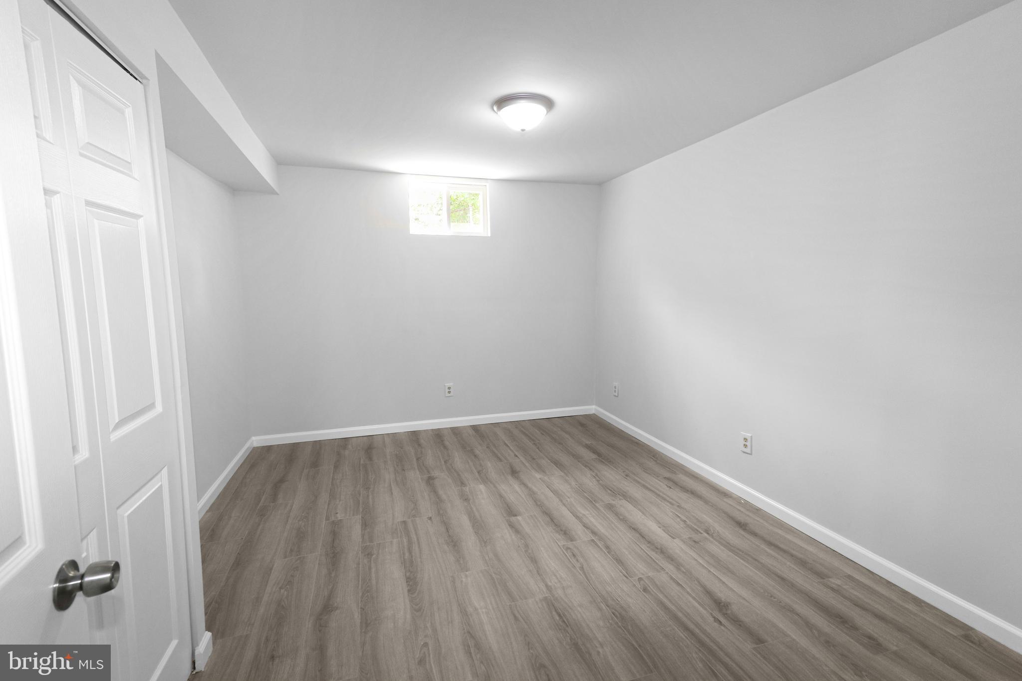 3311 Michele Lane Mitchellville, MD 20721 - Photo 33 of 44 an empty room with wooden floor and windows