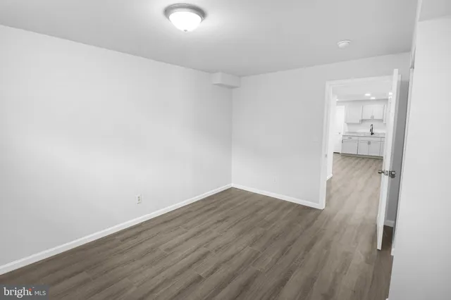 a view of a room with wooden floor