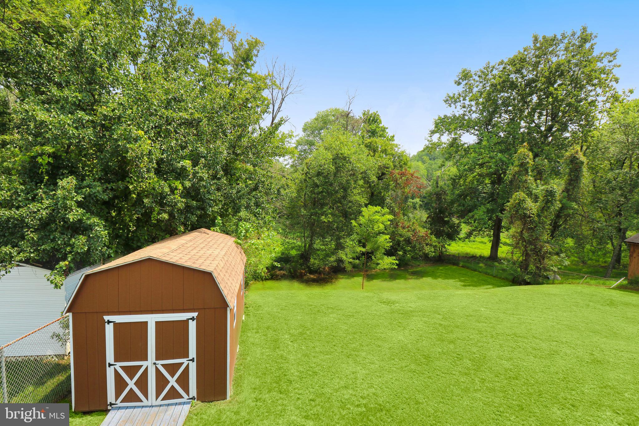 3311 Michele Lane Mitchellville, MD 20721 - Photo 36 of 44 a backyard of a house with yard and trampoline