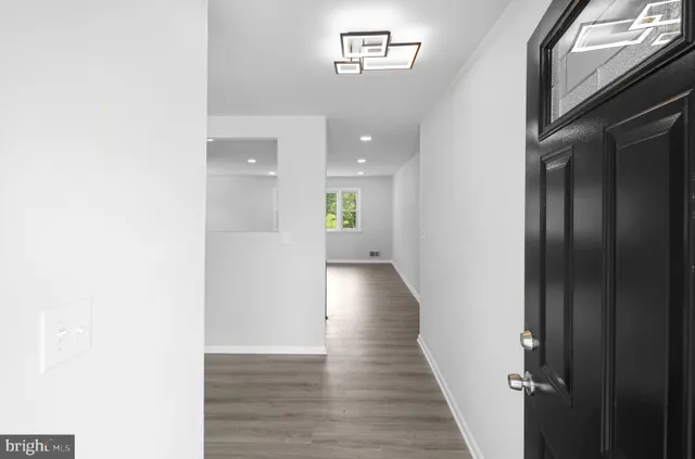a view of a hallway with wooden floor