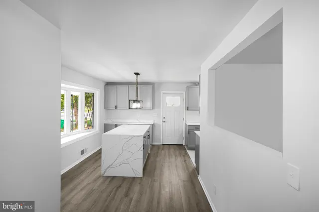 a kitchen with a wooden floor and white appliances
