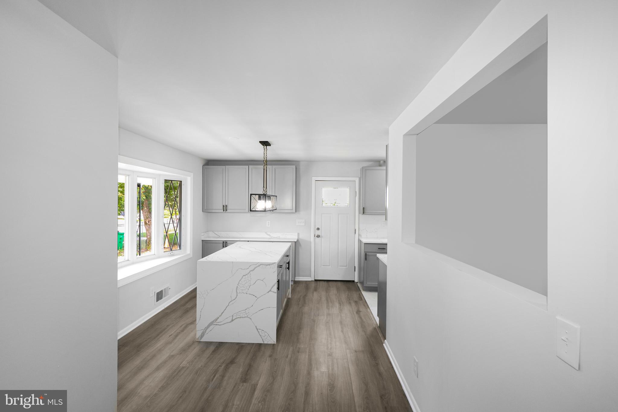 3311 Michele Lane Mitchellville, MD 20721 - Photo 6 of 44 a kitchen with a wooden floor and white appliances