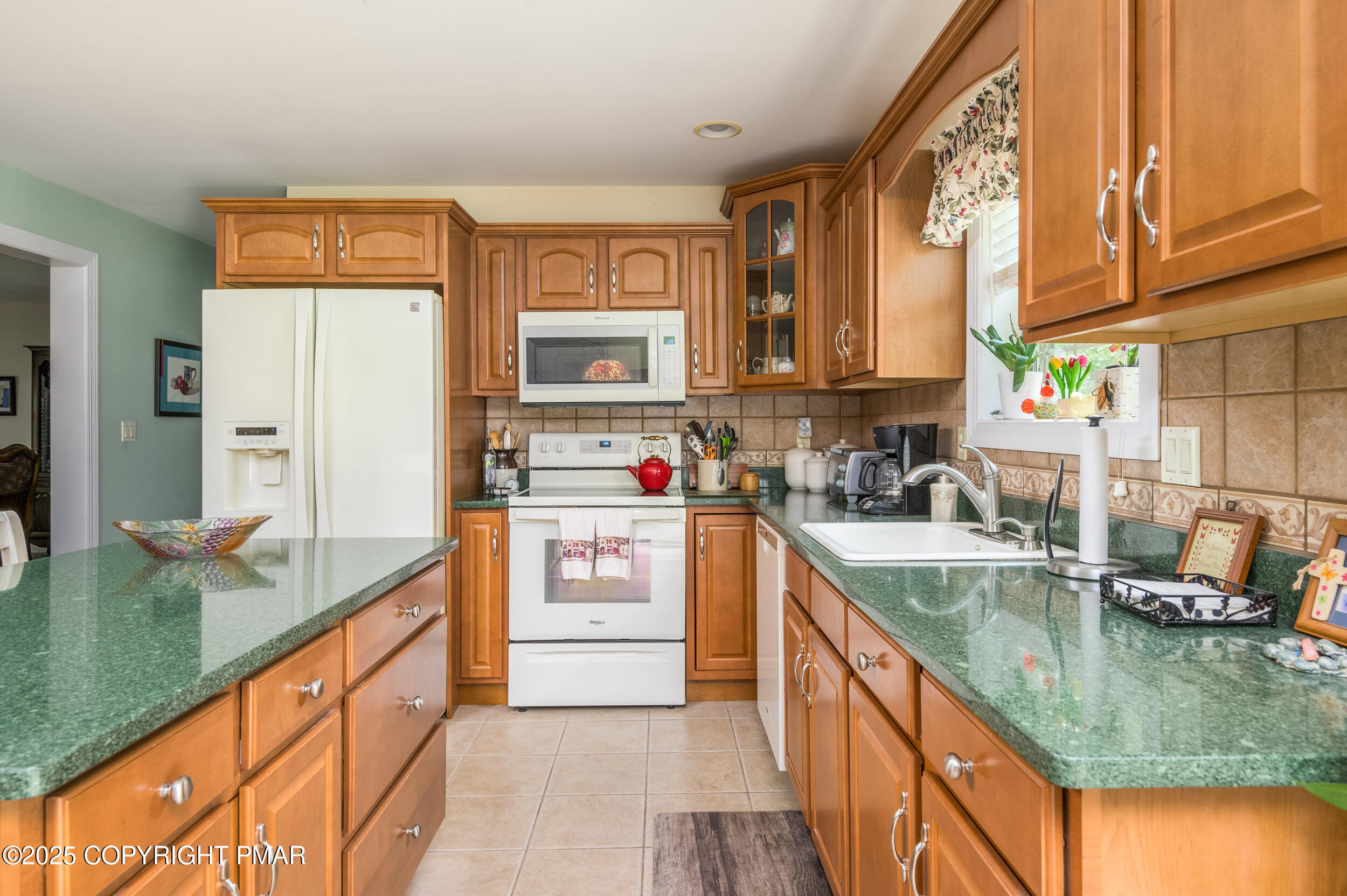 969 Hideaway Hill Road Kunkletown, PA 18058 - Photo 40 of 56 a kitchen with stainless steel appliances granite countertop a stove a sink and a microwave