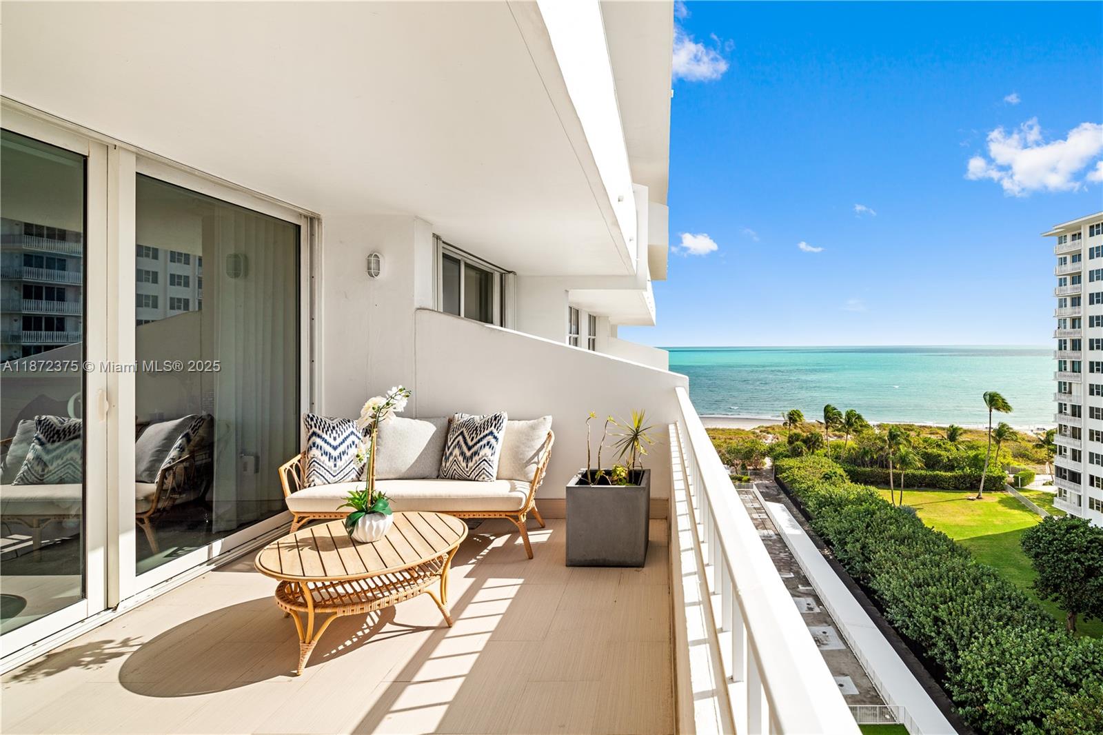 a balcony with furniture and a potted plant