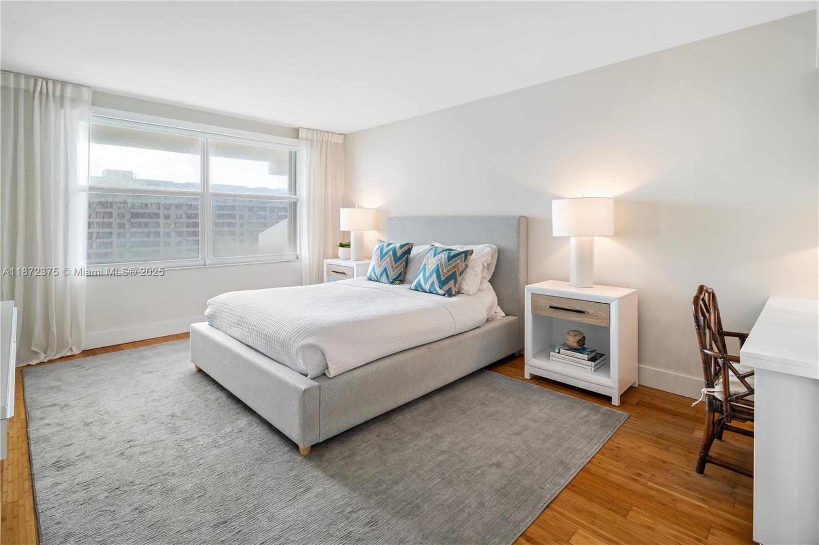 199 Ocean Ln Drive, Unit 1005 Key Biscayne, FL 33149 - Photo 18 of 35 a bedroom with a bed a table and next to a window