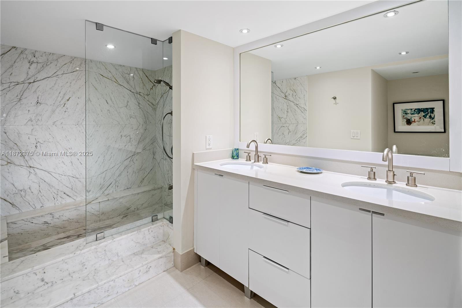 199 Ocean Ln Drive, Unit 1005 Key Biscayne, FL 33149 - Photo 19 of 35 a bathroom with a double vanity sink mirror and shower