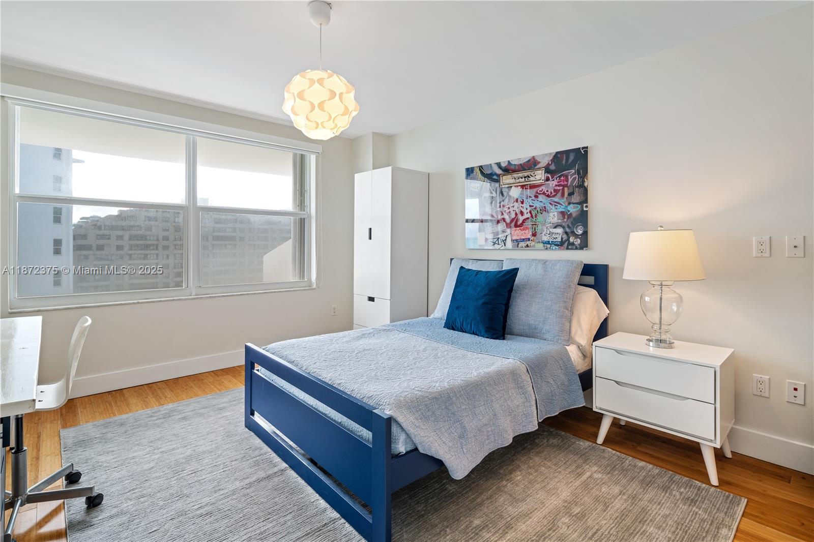 199 Ocean Ln Drive, Unit 1005 Key Biscayne, FL 33149 - Photo 21 of 35 a bedroom with a bed lamp and window