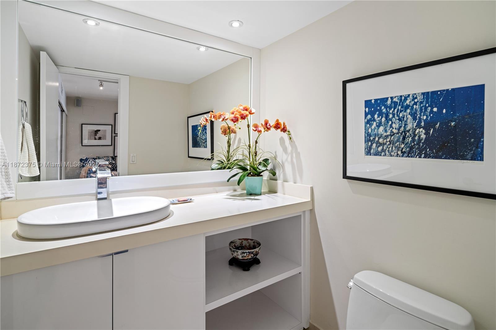 199 Ocean Ln Drive, Unit 1005 Key Biscayne, FL 33149 - Photo 28 of 35 a bathroom with a sink a mirror and a toilet