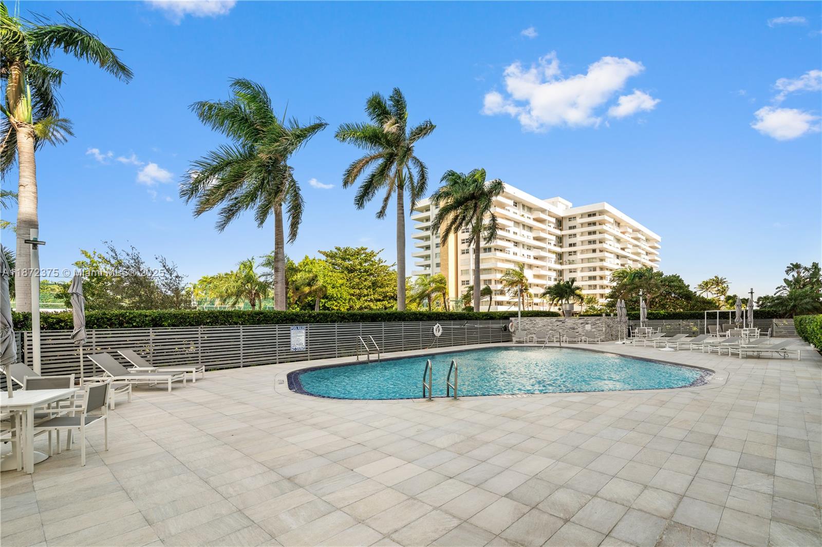 199 Ocean Ln Drive, Unit 1005 Key Biscayne, FL 33149 - Photo 29 of 35 a view of swimming pool with outdoor seating and plants