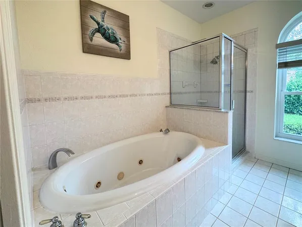 a bathroom with a tub and a shower