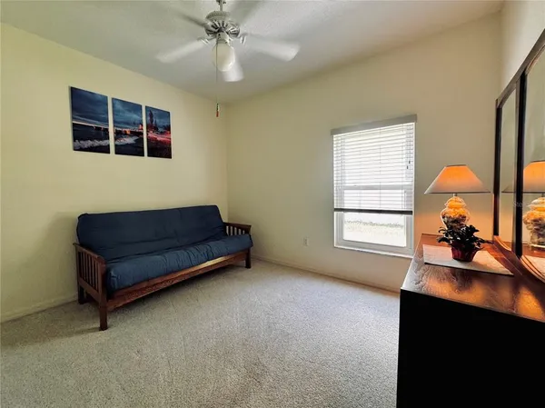 a view of a livingroom with furniture and a window