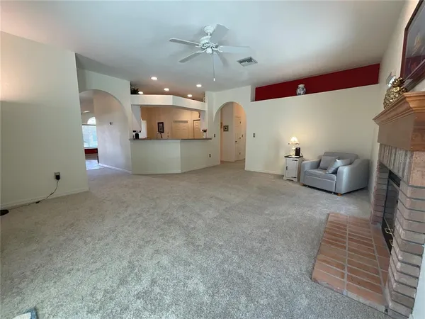a view of a livingroom with furniture and a ceiling fan