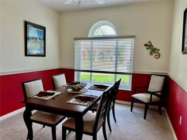 a view of a dining room with furniture and a window