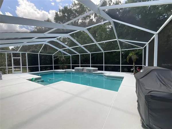 a view of a backyard with floor to ceiling windows
