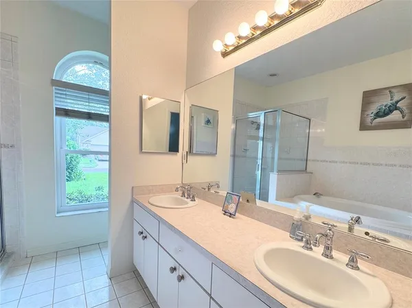 a bathroom with a double vanity sink and a mirror