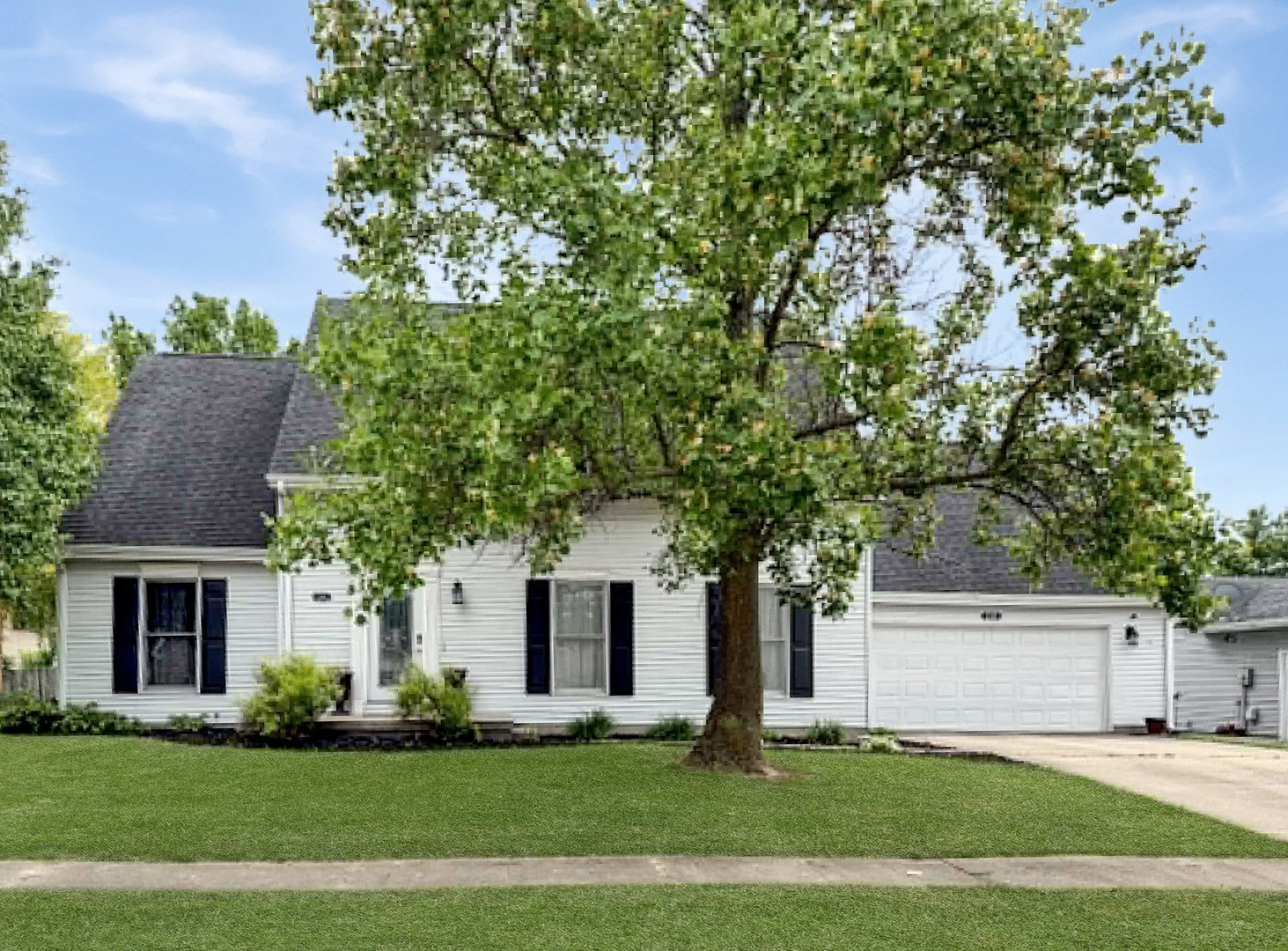 1008 Ascot Drive Rantoul, IL 61866 - Photo 1 of 24 a front view of a house with a garden and trees