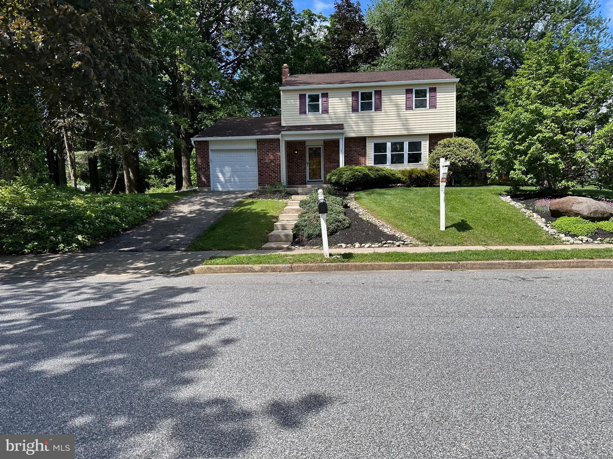 a view of house with outdoor space and tub