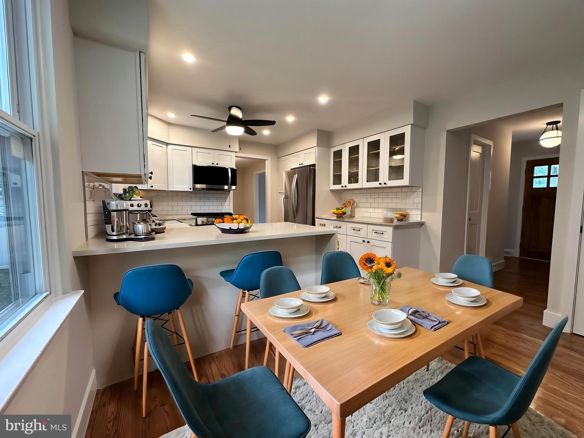 215 Bridge Road Upper Chichester, PA 19061 - Photo 12 of 35 a open dining room with stainless steel appliances a table and chairs